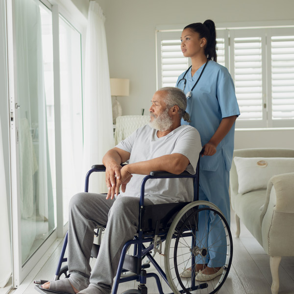 nurse with elderly man in wheelchair
