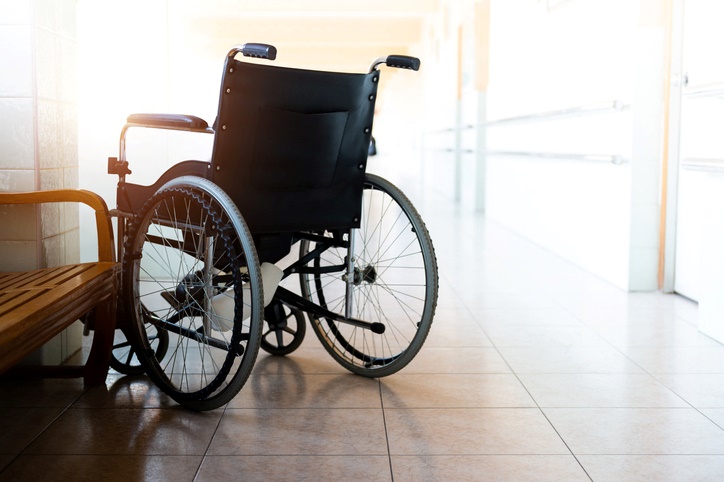 An empty wheelchair in a bright, clean hallway of a medical facility in Houston, TX